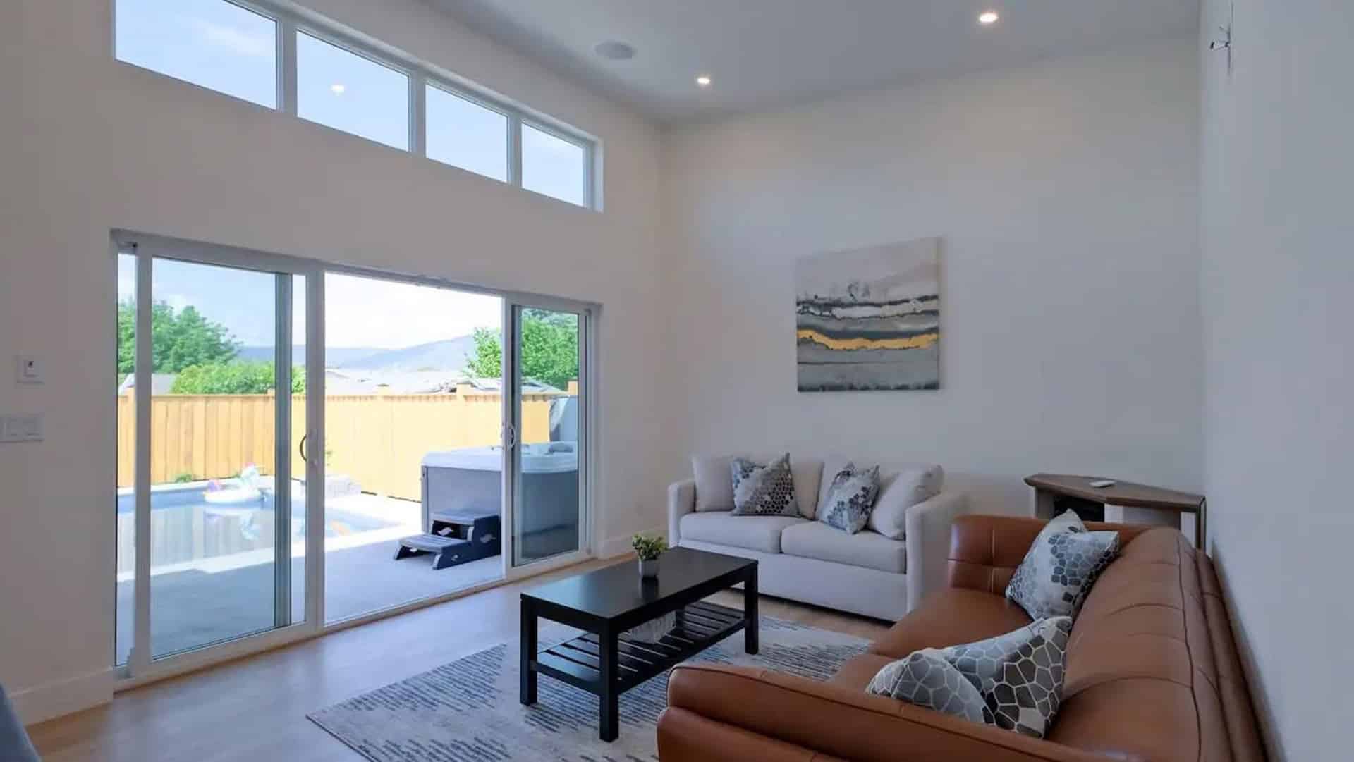 A cozy living room featuring a couch, a coffee table, and sliding glass doors that open to an outdoor space.