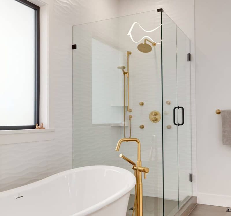 Modern bathroom featuring a sleek design with a gold shower head as the focal point.