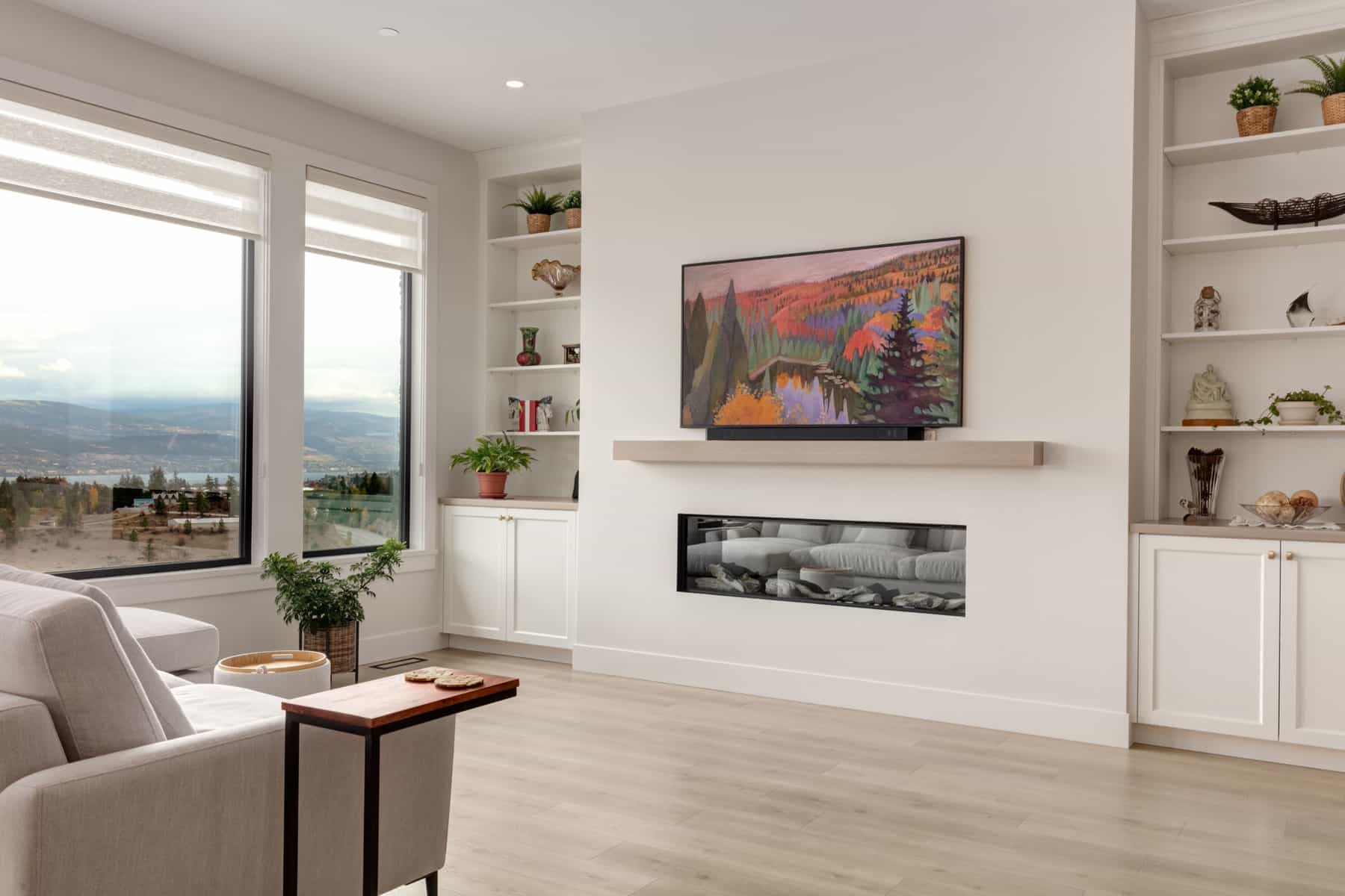 A cozy living room featuring a large flat screen TV mounted on the wall and a warm fireplace, creating a welcoming atmosphere