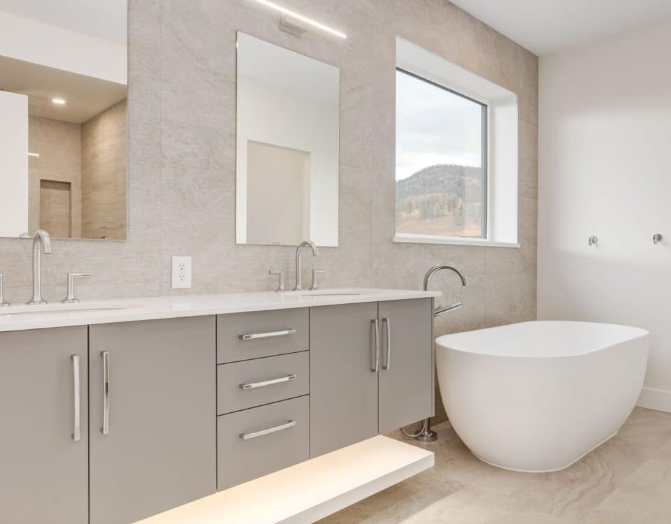 A sleek modern bathroom featuring a stylish tub and a contemporary sink against a minimalist backdrop.