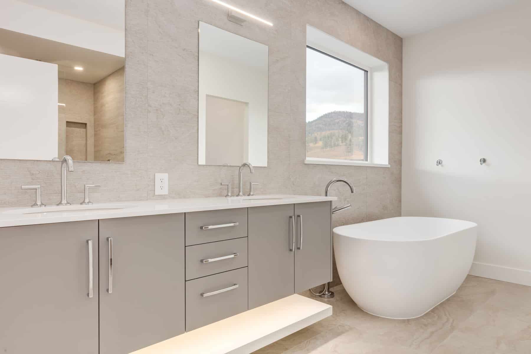 A sleek modern bathroom featuring a stylish tub and a contemporary sink against a minimalist backdrop.