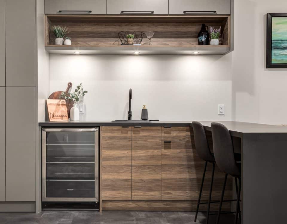 A modern kitchen featuring a wine cooler and stylish bar stools, creating an inviting space for dining and entertaining.