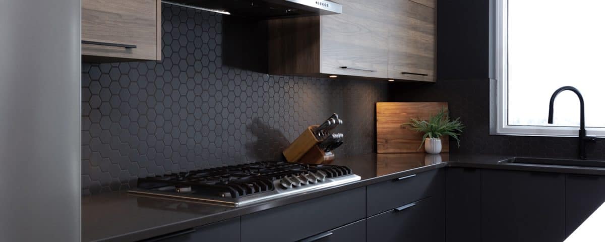 A modern kitchen featuring dark wood cabinets and sleek black appliances, showcasing a stylish and contemporary design.