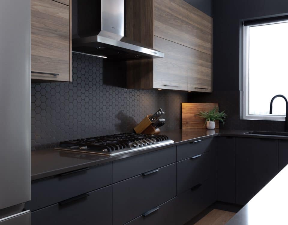 A modern kitchen featuring dark wood cabinets and sleek black appliances, showcasing a stylish and contemporary design.