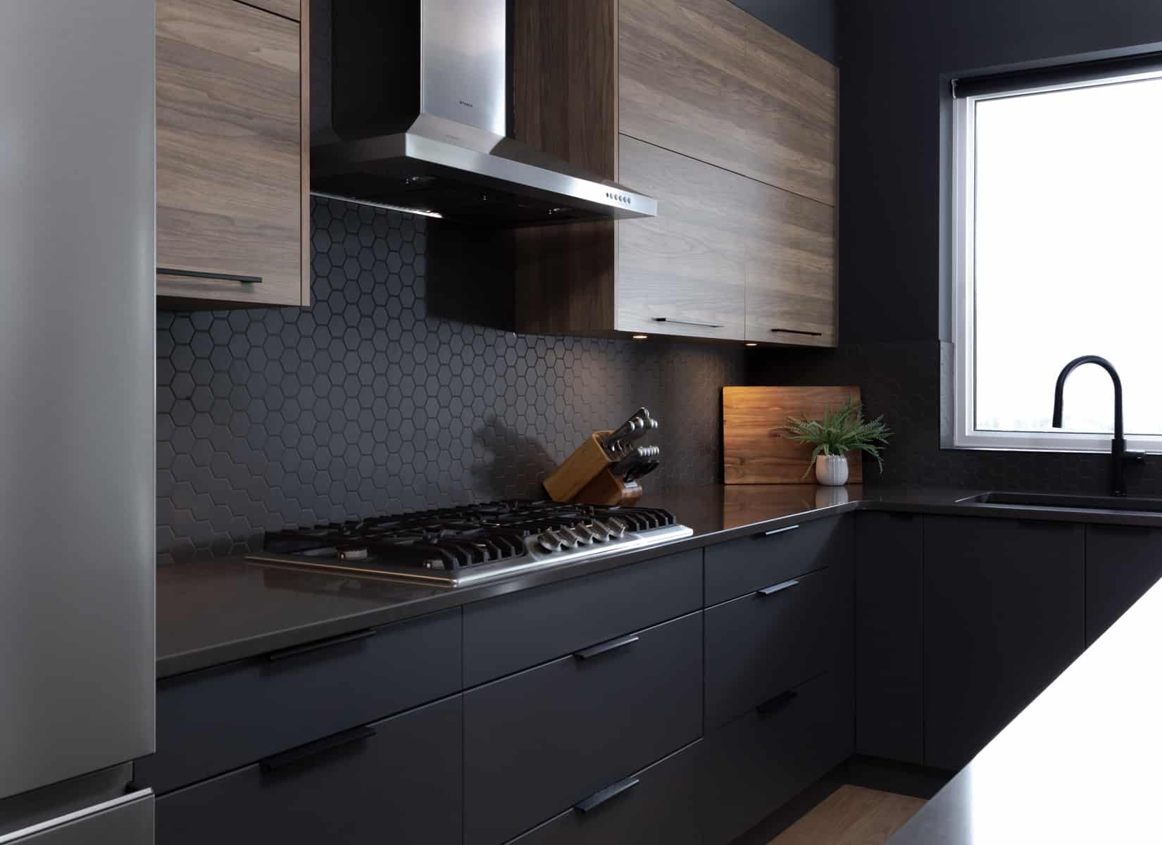 A modern kitchen featuring dark wood cabinets and sleek black appliances, showcasing a stylish and contemporary design.