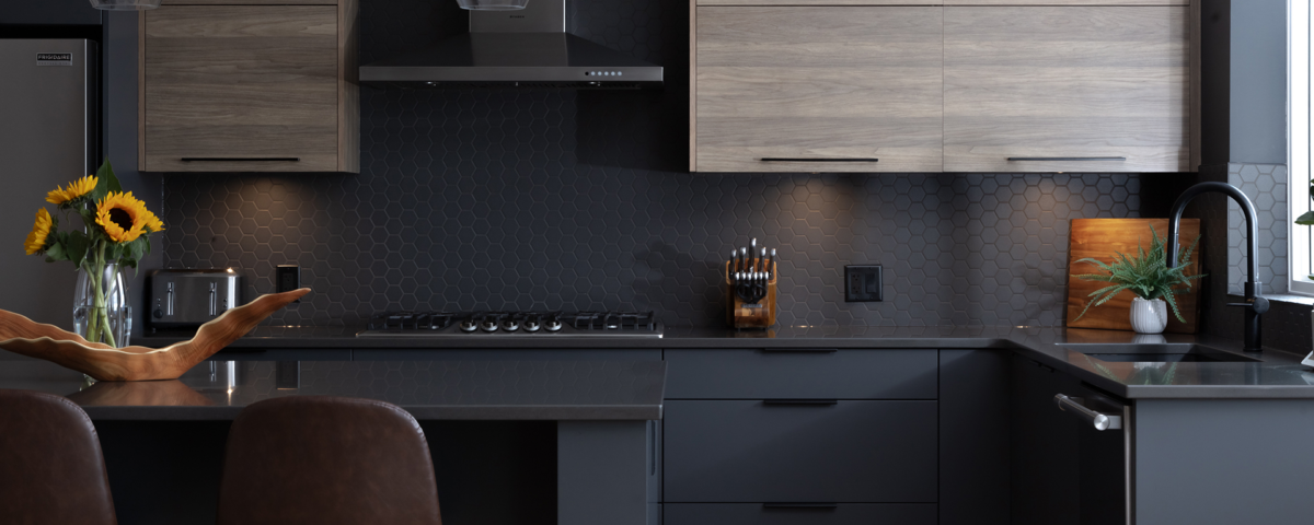 A modern kitchen featuring dark wood cabinets and a sleek black countertop, creating a stylish and elegant atmosphere.