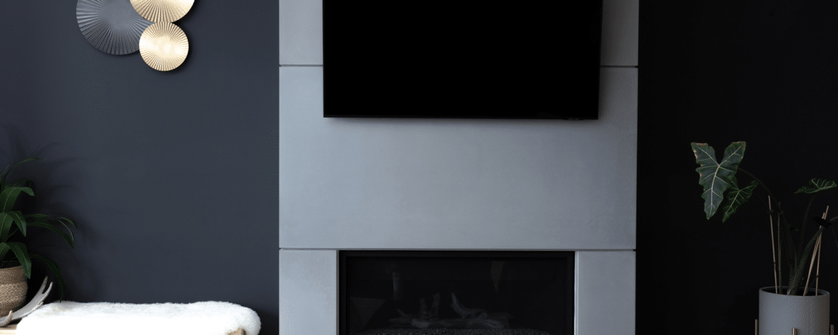 A contemporary living room featuring a cozy fireplace and a flat-screen TV mounted on the wall.