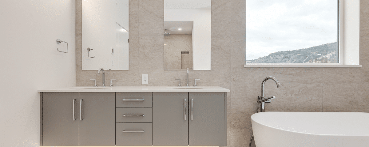 A spacious bathroom featuring a large bathtub and a modern sink, showcasing a clean and elegant design.