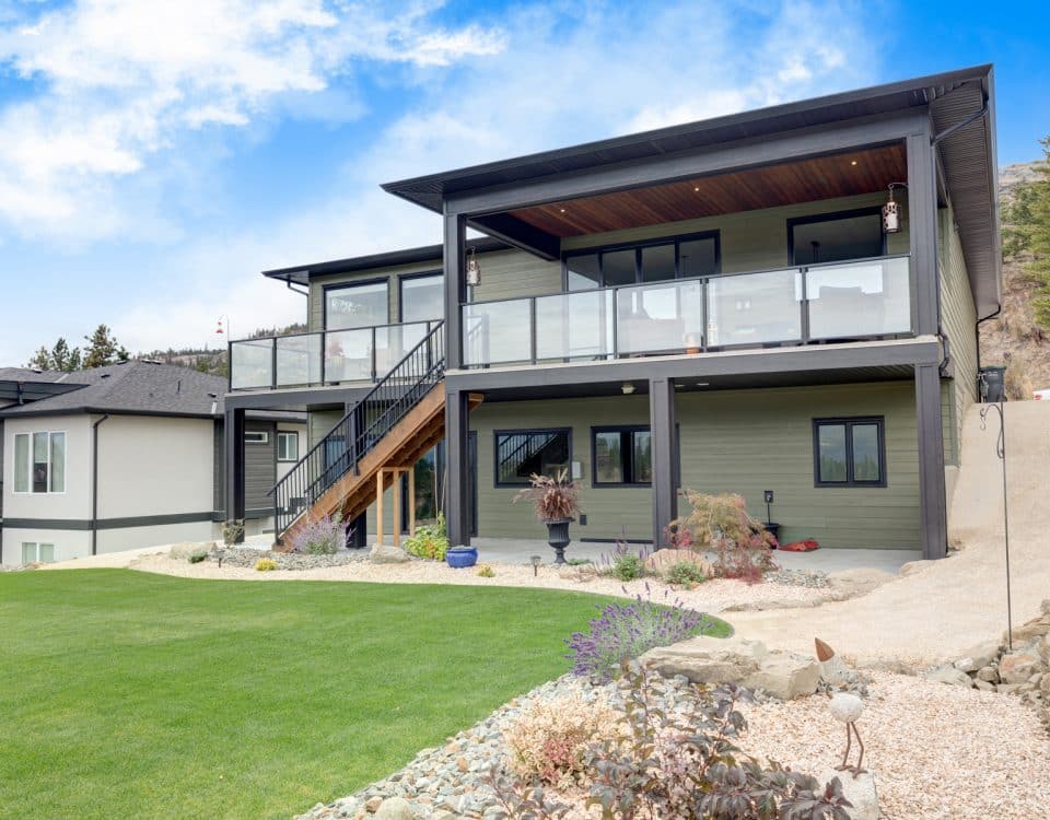 A spacious home featuring a large yard and an expansive deck, ideal for outdoor activities and gatherings.