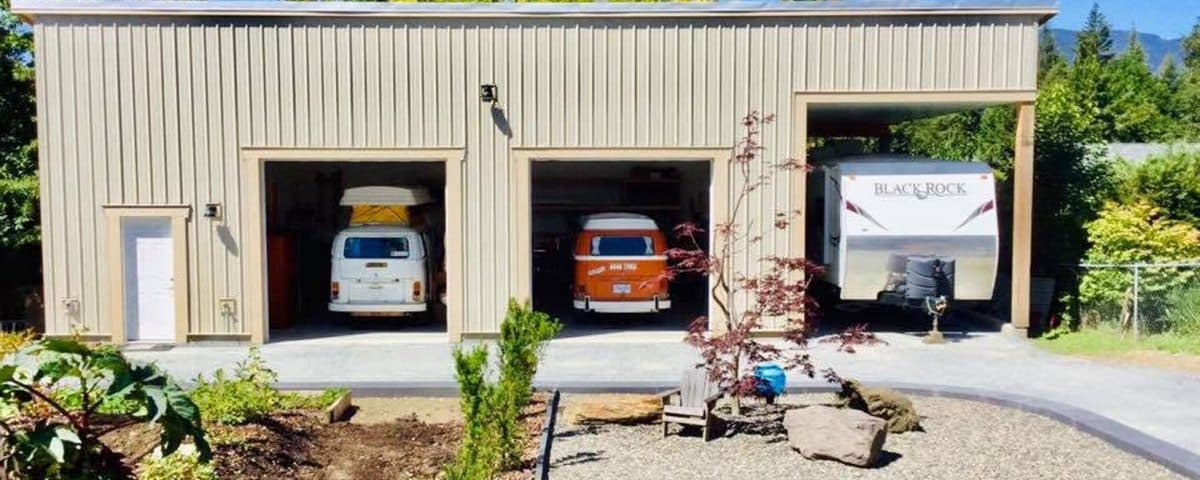 A garage interior featuring two parked vans, showcasing a spacious and organized vehicle storage area.
