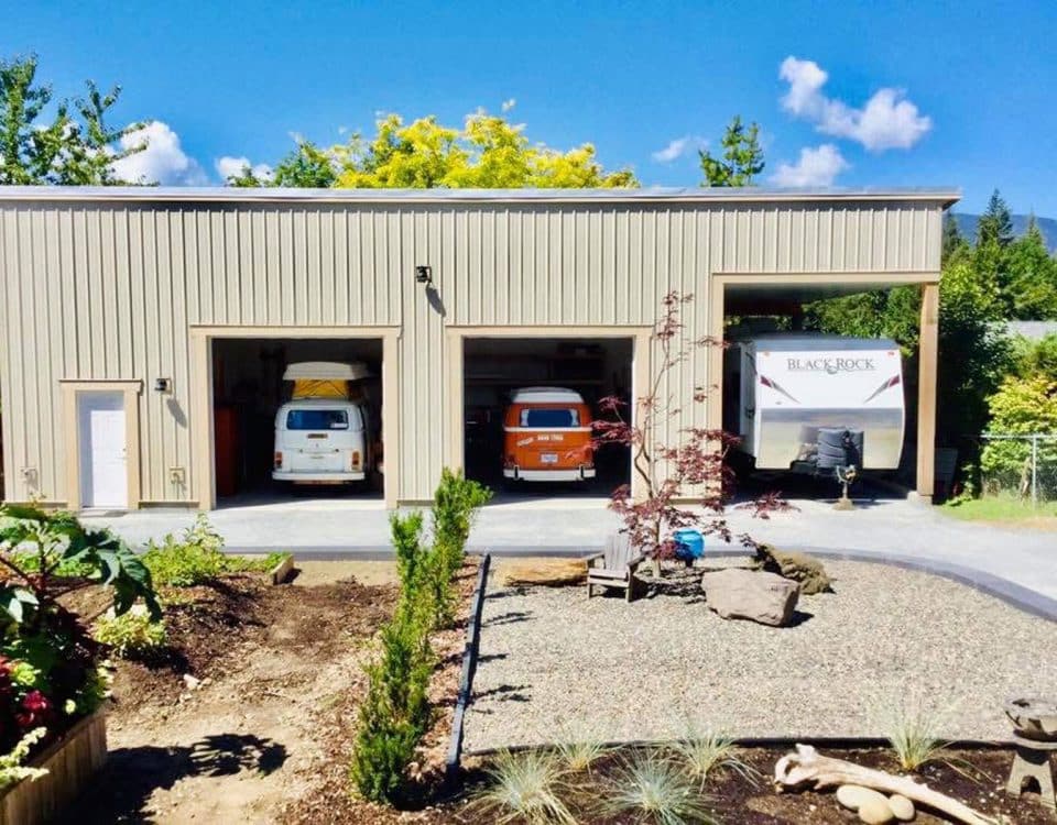 A garage interior featuring two parked vans, showcasing a spacious and organized vehicle storage area.