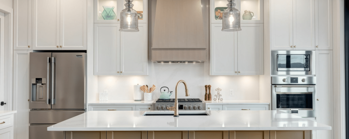 A modern kitchen featuring sleek white cabinets and vibrant yellow chairs, creating a bright and inviting atmosphere.