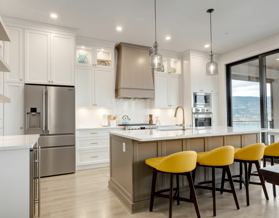 A modern kitchen featuring sleek white cabinets and vibrant yellow stools, creating a bright and inviting atmosphere.