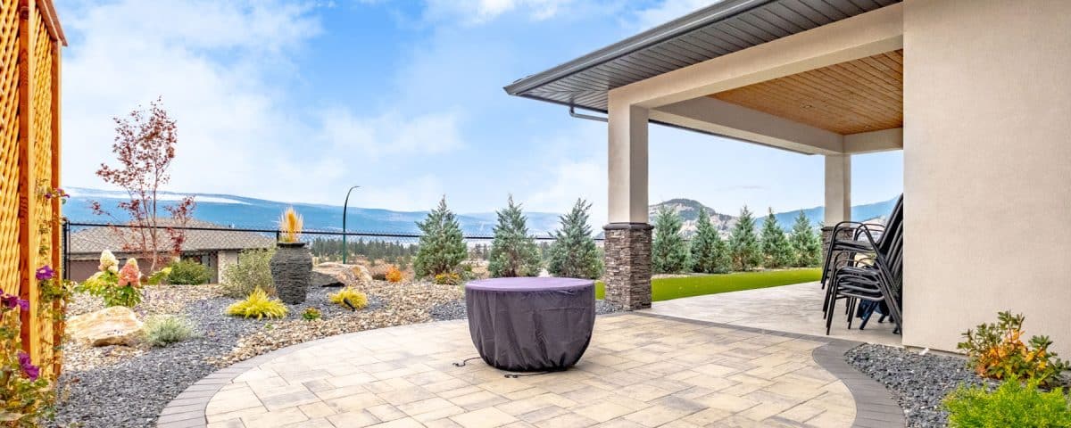 A spacious patio featuring a cozy fire pit surrounded by seating, ideal for outdoor gatherings and relaxation.