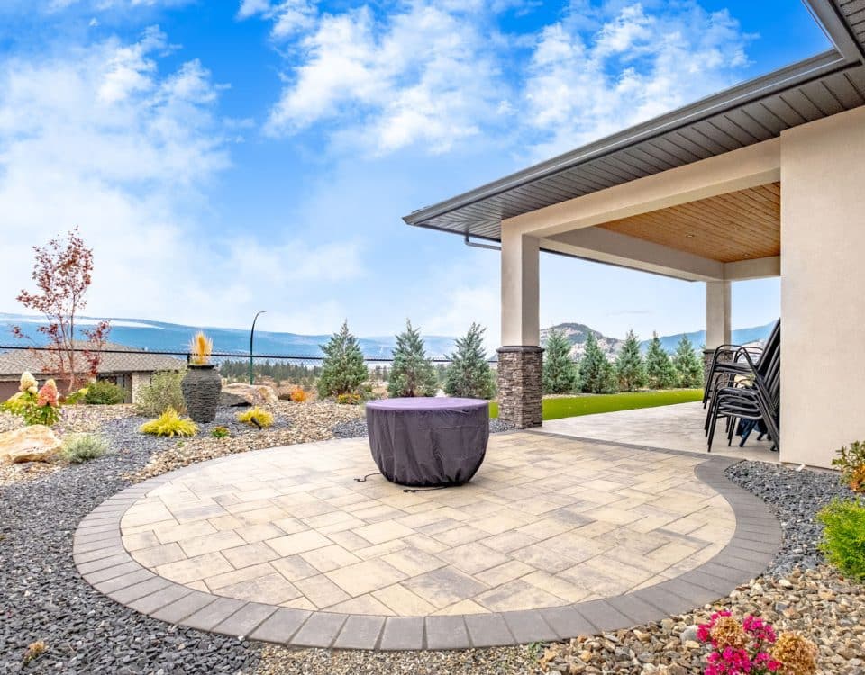A spacious patio featuring a cozy fire pit surrounded by seating, ideal for outdoor gatherings and relaxation.