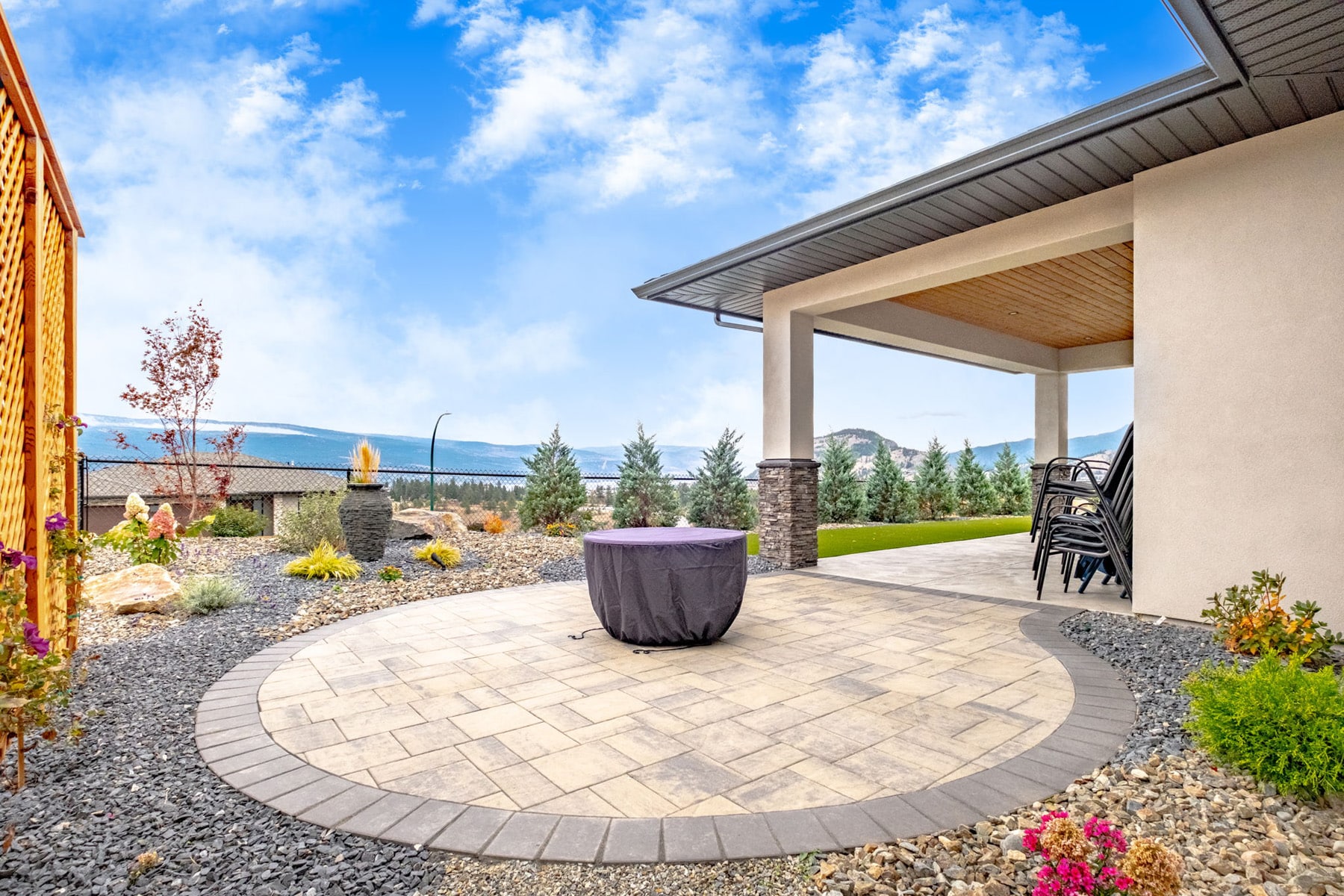 A spacious patio featuring a cozy fire pit surrounded by seating, ideal for outdoor gatherings and relaxation.