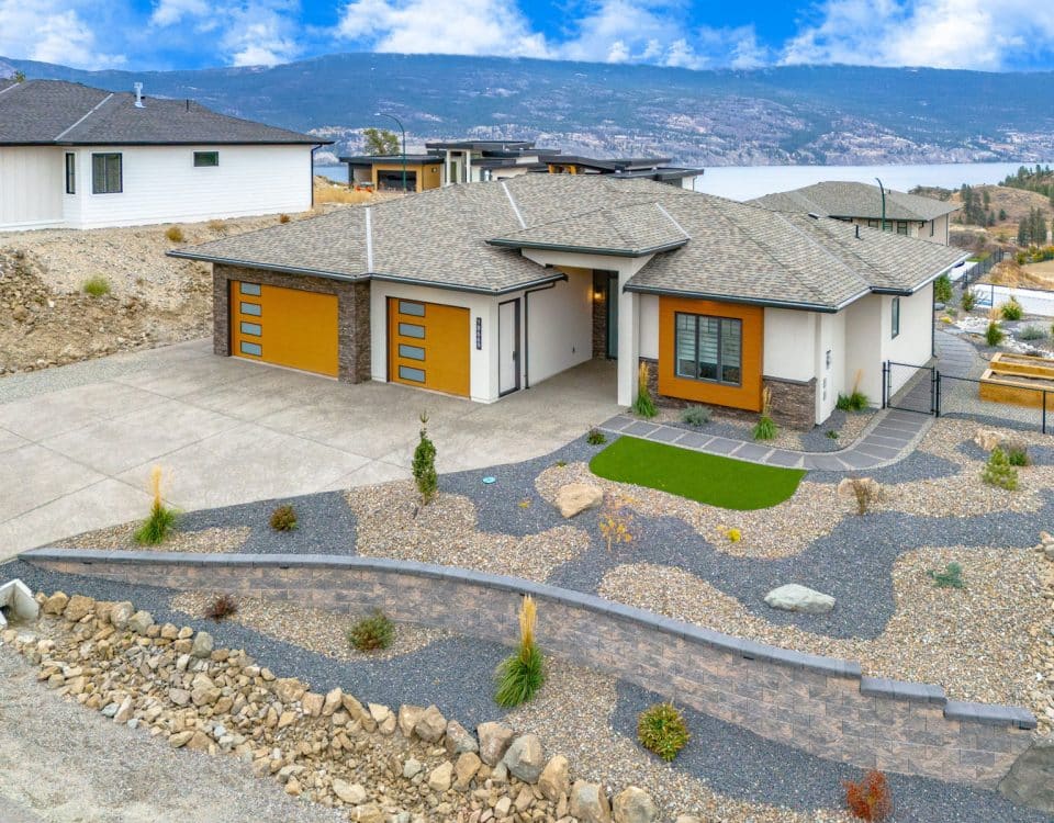 A spacious home featuring a large driveway and well-maintained landscaping, showcasing a welcoming outdoor environment.