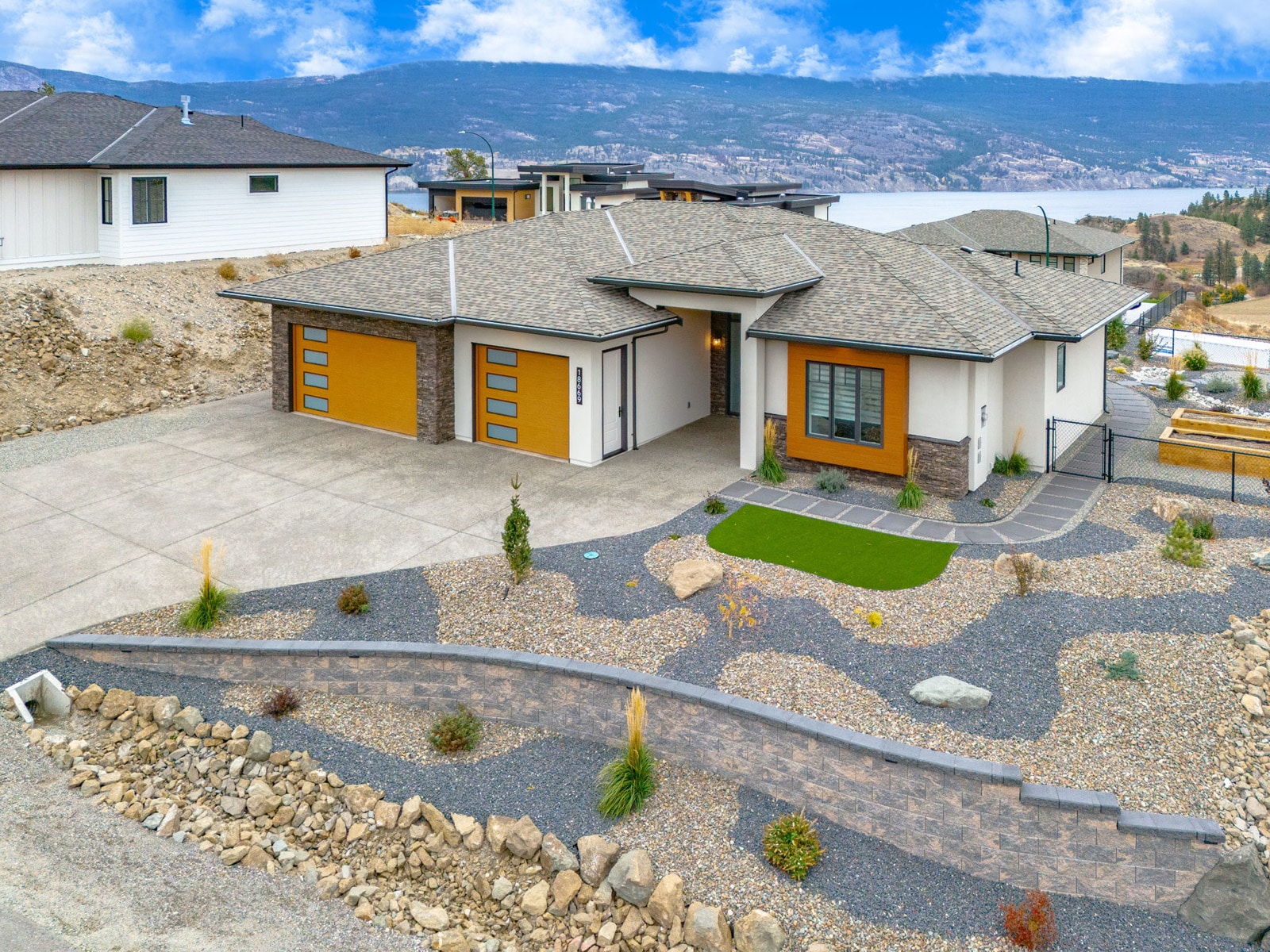 A spacious home featuring a large driveway and well-maintained landscaping, showcasing a welcoming outdoor environment.