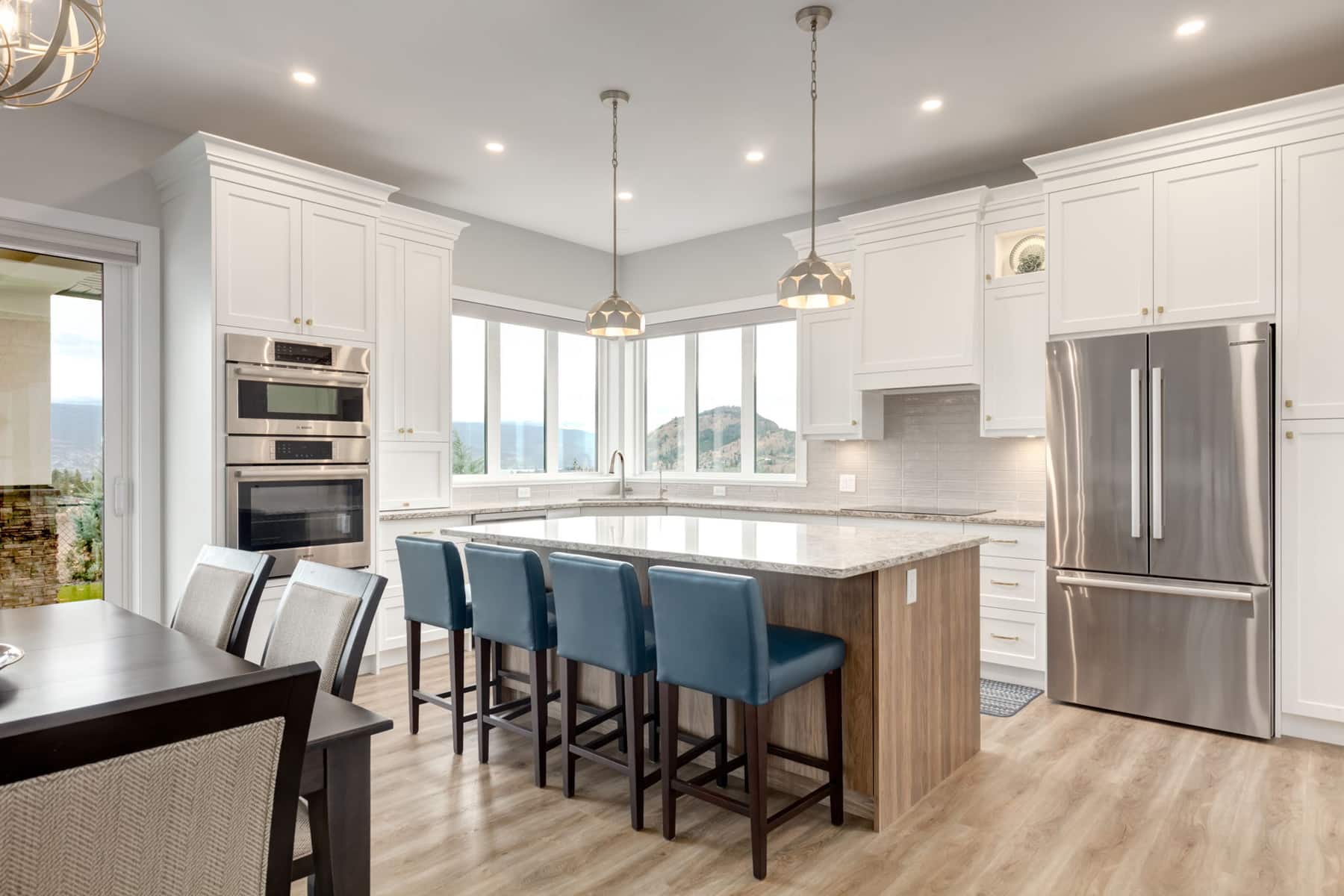 A modern kitchen featuring a central island and sleek stainless steel appliances, showcasing a clean and functional design.