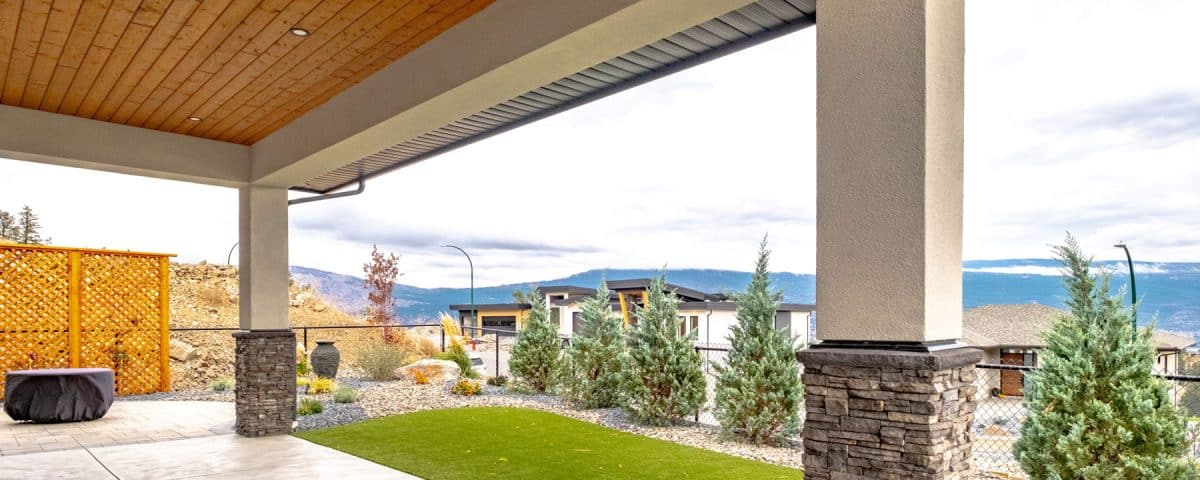 A covered patio overlooking scenic mountains, providing a tranquil outdoor space for relaxation and enjoyment.