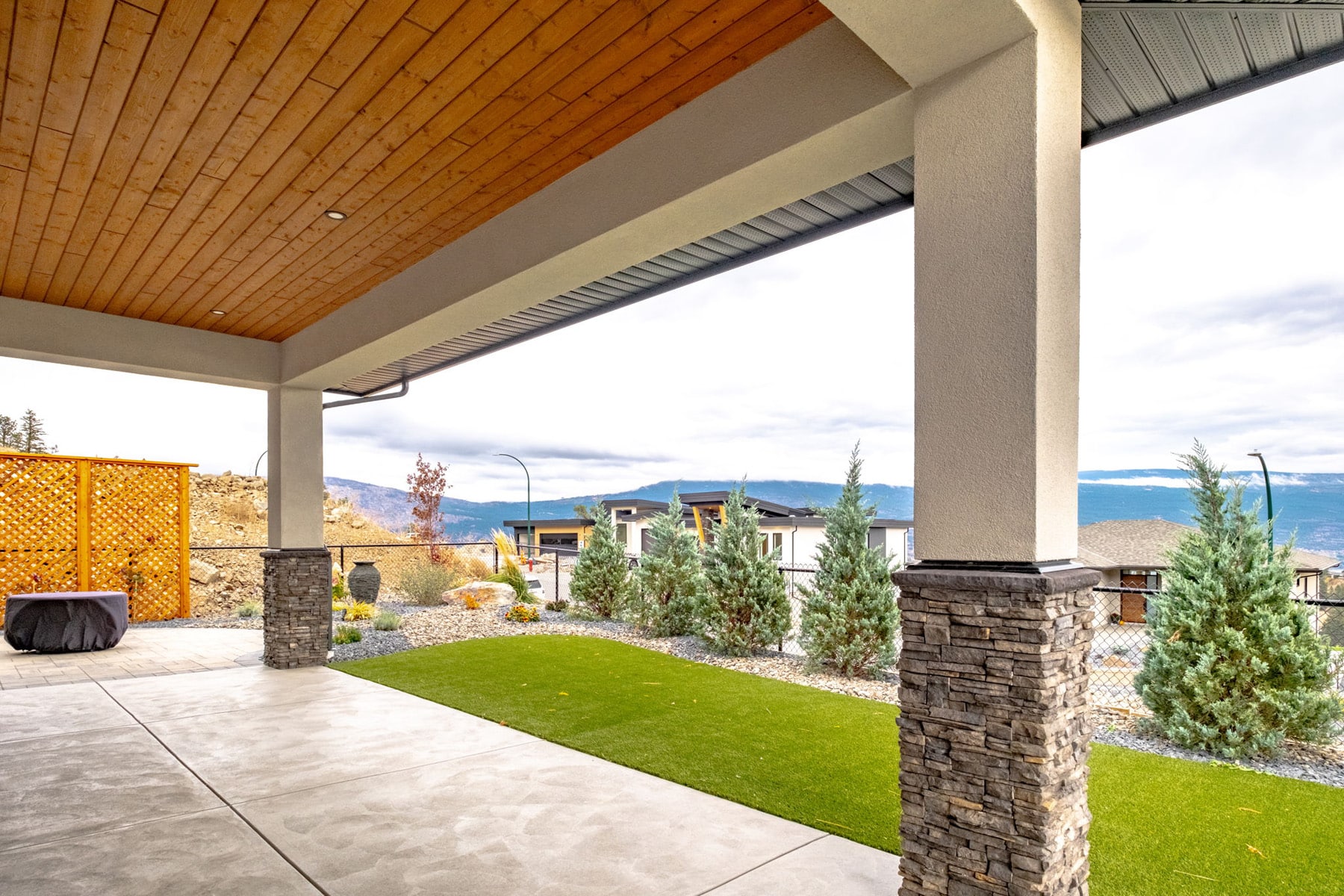 A covered patio overlooking scenic mountains, providing a tranquil outdoor space for relaxation and enjoyment.